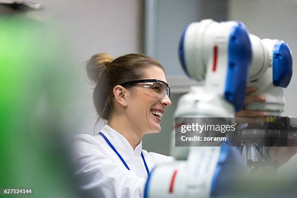 female engineers working on robotic arm development - robotics stock pictures, royalty-free photos & images