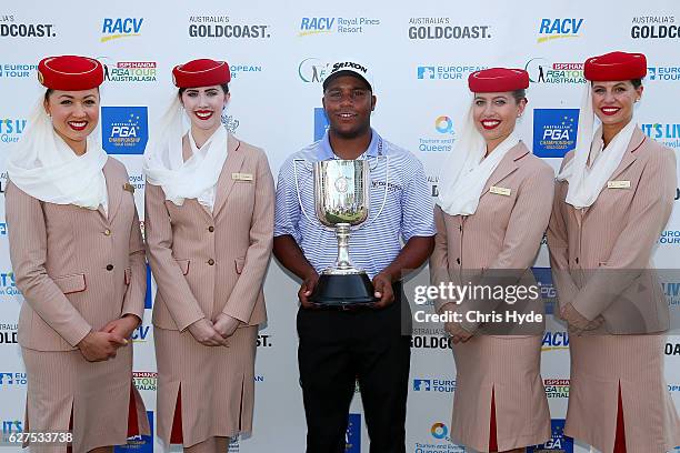 Harold Varner III of the USA poses with Emirates cabin crew after winning the Joe Kirkwood trophy on day four of the 2016 Australian PGA Championship...