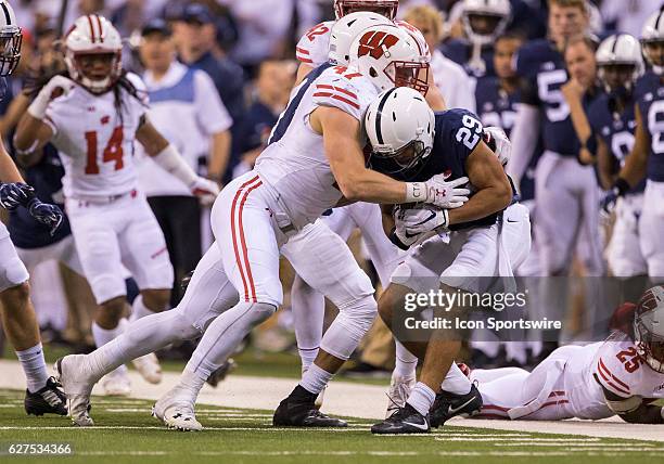 Linebacker Vince Biegel of the Wisconsin Badgers tackles cornerback John Reid of the Penn State Nittany Lions during the Big Ten Championship Game...