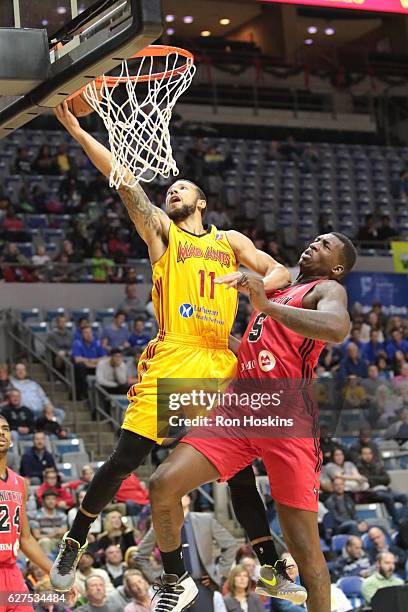 Trey McKinney Jones of the Fort Wayne Mad Ants lays the ball up over Coreontae DeBerry of the Windy City Bulls during their NBDL game at Memorial...