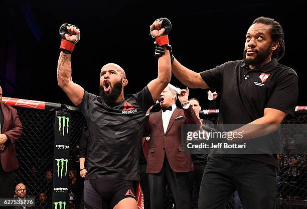 Demetrious Johnson celebrates his unanimous-decision victory over Timothy Elliott in their flyweight championship bout during The Ultimate Fighter...
