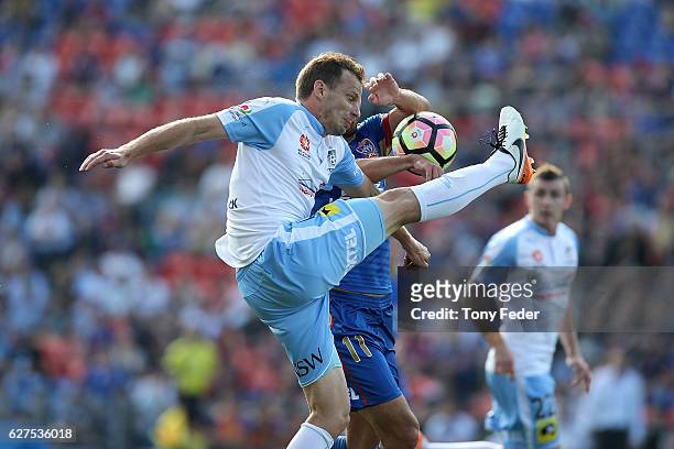 Alexander Wilkinson of Sydney Fc contests the ball with Labinot Haliti of the Jets during the round nine A-League match between the Newcastle Jets...