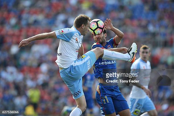Alexander Wilkinson of Sydney Fc contests the ball with Labinot Haliti of the Jets during the round nine A-League match between the Newcastle Jets...