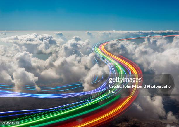 light trails in clouds in sky - lichtspur stock-fotos und bilder