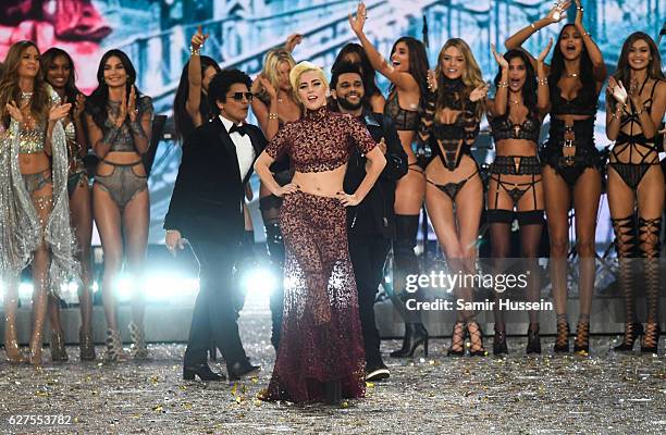 Bruno Mars, Lady Gaga and The Weeknd walk the runway as model look on during the annual Victoria's Secret fashion show at Grand Palais on November...