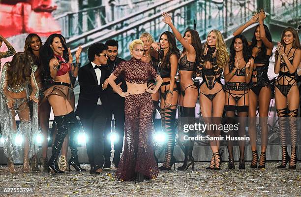 Bruno Mars, Lady Gaga and The Weeknd walk the runway as model look on during the annual Victoria's Secret fashion show at Grand Palais on November...
