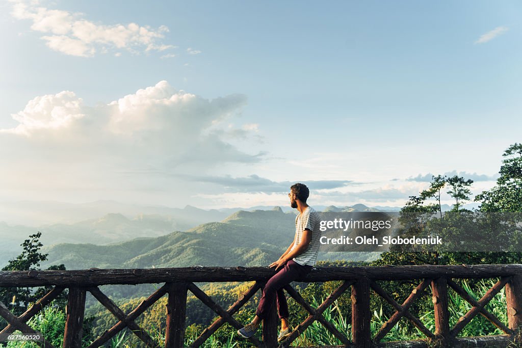 Man in mountains at sunset in Thailand