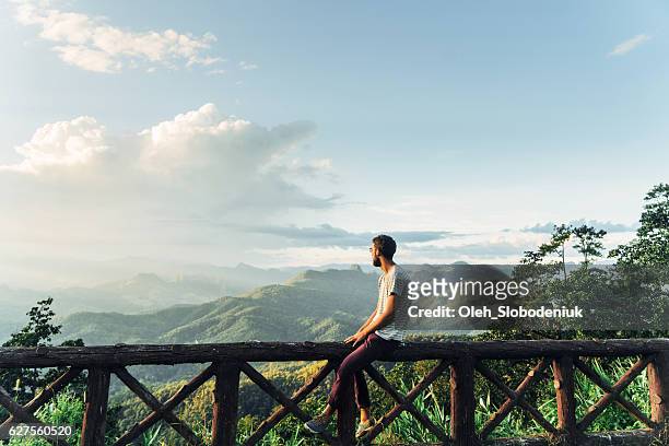 Man in mountains at sunset in Thailand