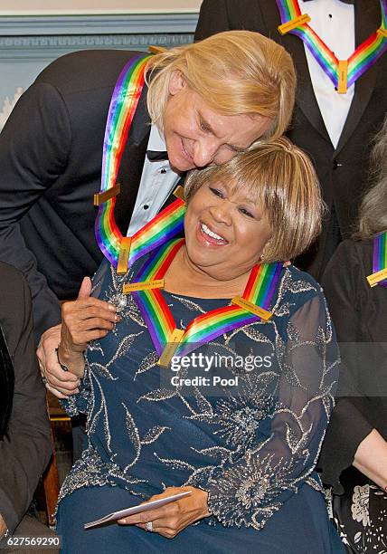 Joe Walsh of the rock band "The Eagles," left, one of the five recipients of the 39th Annual Kennedy Center Honors, hugs gospel and blues singer...