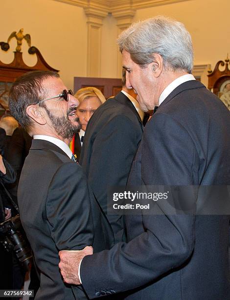 TUnited States Secretary of State John Kerry speaks with Ringo Starr, left, following a dinner at the U.S. Department of State in Washington, D.C. On...