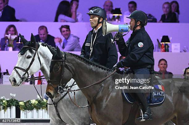 Nicolas Canteloup and Marc Dilasser, as policemen on strike, compete in the annual Pro-Am Charity show jumping event during the Paris Longines...