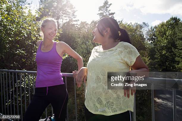 female joggers resting and chatting - chubby arab stock pictures, royalty-free photos & images
