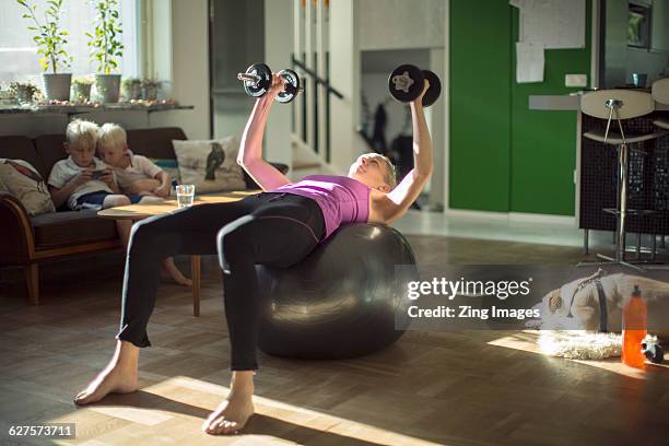 woman exercising at home - home workout foto e immagini stock