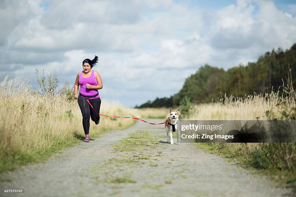 Woman running with dog