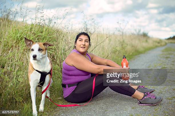 female runner with dog - running shoes sky stock-fotos und bilder