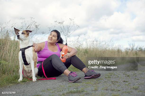 female runner with dog - chubby arab stock pictures, royalty-free photos & images