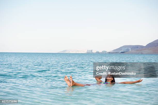 the perfect vacation on salty lake. - dead sea float stock pictures, royalty-free photos & images