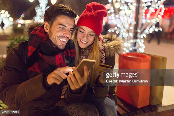 happy family shopping online for christmas - public celebratory event stock pictures, royalty-free photos & images