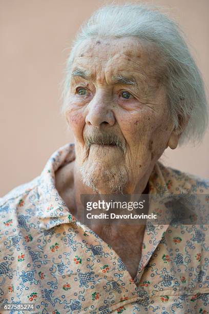 portrait of an very  old lady with look on left - hairy women stock pictures, royalty-free photos & images