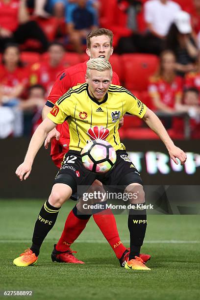 Adam Parkhouse of Wellington Phoenix and Ryan Kitto of Adelaide United compete for the ball during the round nine A-League match between Adelaide...