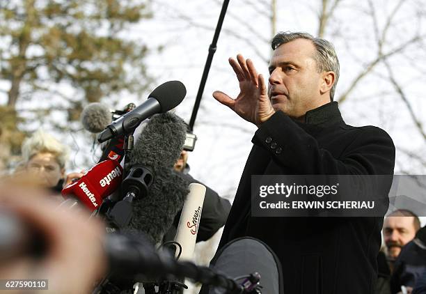 Austrian far-right Freedom Party presidential candidate Norbert Hofer talks to journalists as he leaves a polling station after he casted his ballot...