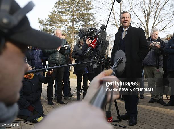 Austrian far-right Freedom Party presidential candidate Norbert Hofer talks to journalists at a polling station after he casted his ballot in...