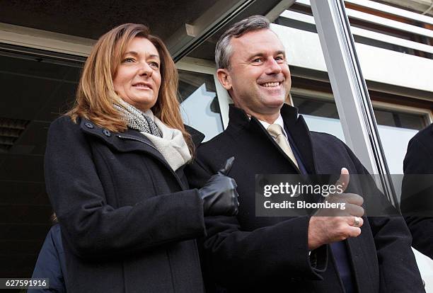 Norbert Hofer, presidential candidate of Austria's Freedom party, right, and his wife Verena Hofer, left, give a thumbs-up sign as they pose for the...