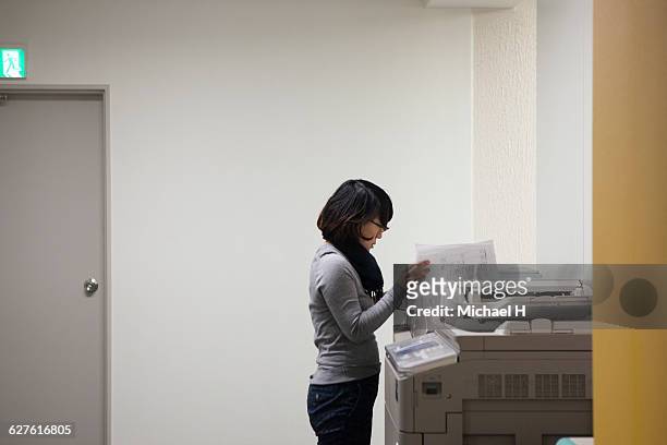 woman using photocopier - japanese exit sign stock pictures, royalty-free photos & images