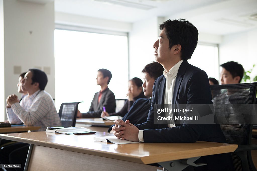 People watching presentation in conference room