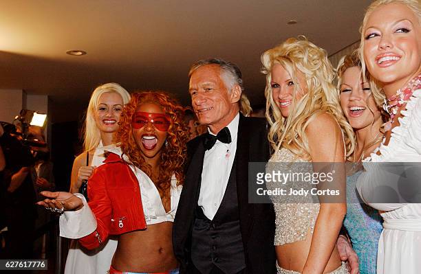 Hugh Hefner, Lil' Kim and his Hefner's girlfriends greet each other at the Warner Music Group and Entertainment Weekly post-Grammy party.