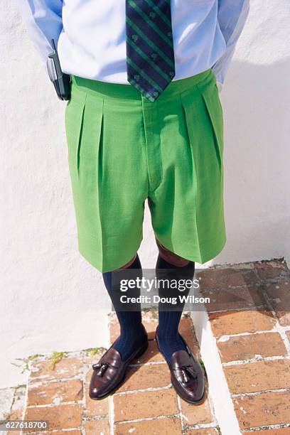 businessman wearing green shorts - bermudainseln stock-fotos und bilder