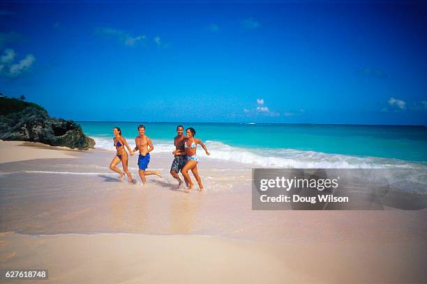 couples frolicking on the beach - bermuda beach imagens e fotografias de stock