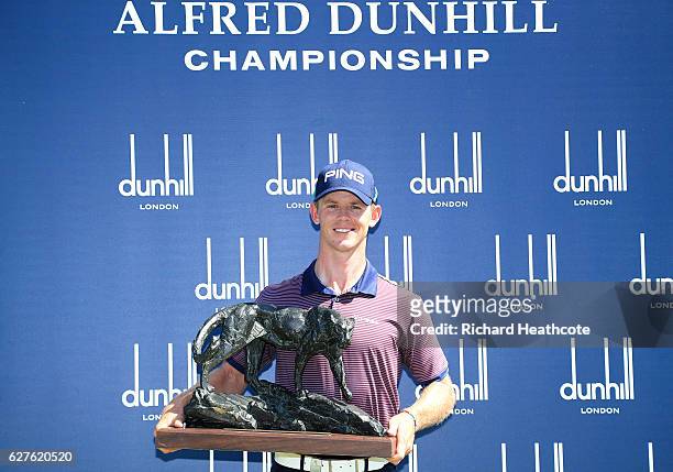 Brandon Stone of South Africa holds the winners trophy following victory during the final round of The Alfred Dunhill Championship at Leopard Creek...