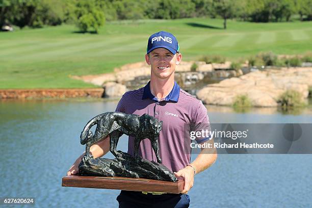 Brandon Stone of South Africa holds the winners trophy following victory during the final round of The Alfred Dunhill Championship at Leopard Creek...