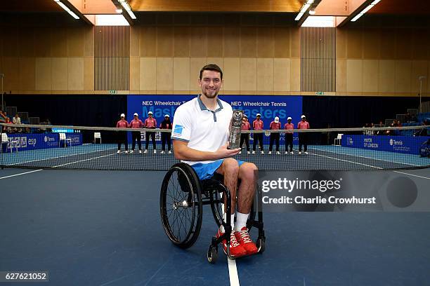 Joachim Gerard of Belgium poses for a photo with his trophy after winning the mens final match against Gordon Reid of Great Britain on Day 5 of the...