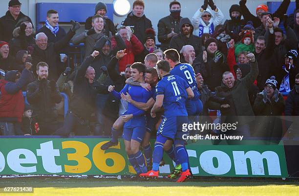Adam Morgan of Curzon Ashton celebrates with team mates and fans as he scores their third goal and completes his hat trick during the Emirates FA Cup...