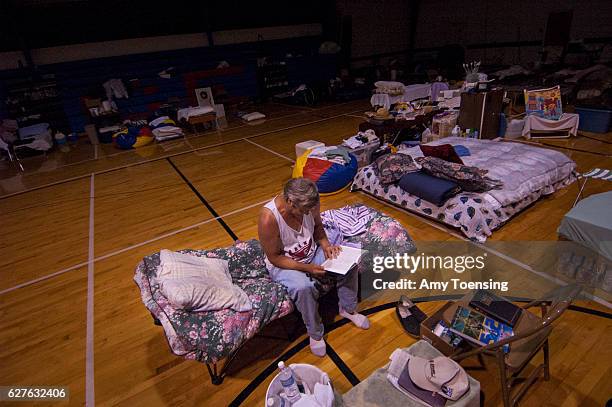 Individuals displaced by Hurricane Katrina, which hit the Gulf Coast of the United States on August 30 take shelter in and around a school.