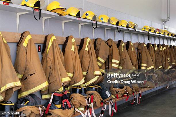 firefighters' suits - firefighters foto e immagini stock