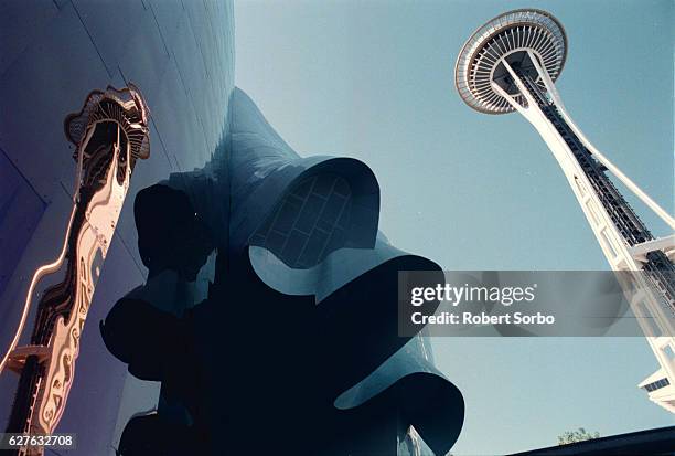 The Space Needle is reflected on the skin of the just completed Experience Music Project Museum.