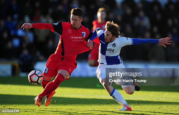 Luke James of Bristol Rovers is tackled by Shaun Beeley of Barrow FC during the Emirates FA Cup Second Round match between Bristol Rovers and Barrow...