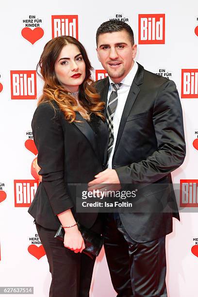 Boxing champion Marco Huck and his wife Amina Huck attend the Ein Herz Fuer Kinder gala on December 3, 2016 in Berlin, Germany.
