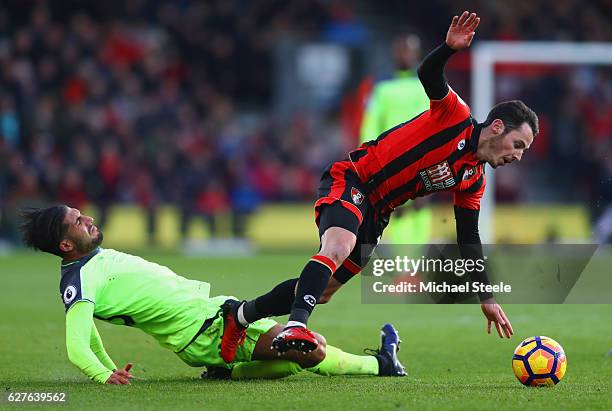 Adam Smith of AFC Bournemouth is tackled by Emre Can of Liverpool during the Premier League match between AFC Bournemouth and Liverpool at Vitality...