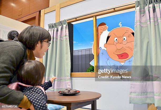 Japan - Visitors react to the recorded voice of Ichiro Nagai, the voice behind the character Namihei Isono in the popular anime series ''Sazae san,''...