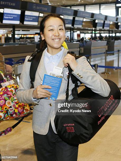 Japan - Mao Asada, who won the silver medal in the women's figure skating event at the 2010 Vancouver Winter Olympics, smiles as she leaves Narita...