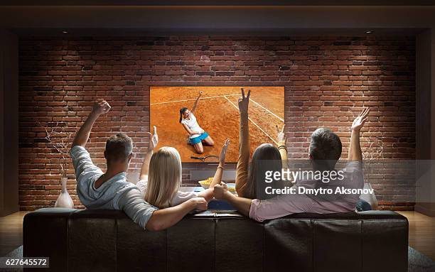 couples watching tennis game at home - tennis quick stock pictures, royalty-free photos & images