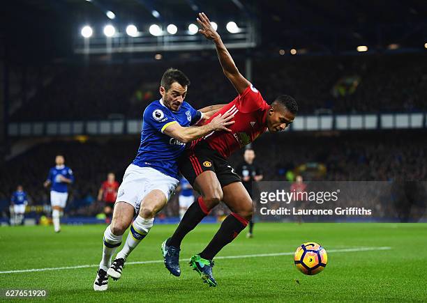 Antonio Valencia of Manchester United holds off Leighton Baines of Everton during the Premier League match between Everton and Manchester United at...