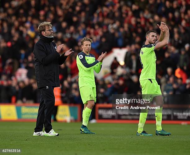 Jurgen Klopp manager of Liverpool, Lucas Leiva and Jordan Henderson shows their appreciation to the fans at the end of the Premier League match...