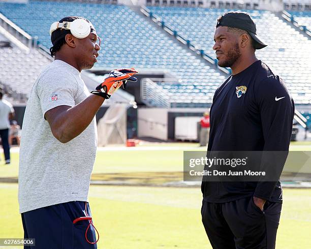 Tight End Virgil Green of the Denver Broncos talk with Tight End Julius Thomas of the Jacksonville Jaguars before the game at EverBank Field on...