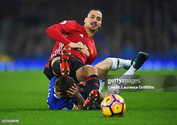 Zlatan Ibrahimovic of Manchester United tangles with Seamus Coleman of Everton as they battle for the ball during the Premier League match between...