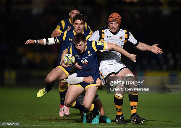 Josh Adams of Worcester Warriors is tackled by Rob Miller and Kearnan Myall of Wasps during the Aviva Premiership match between Worcester Warriors...